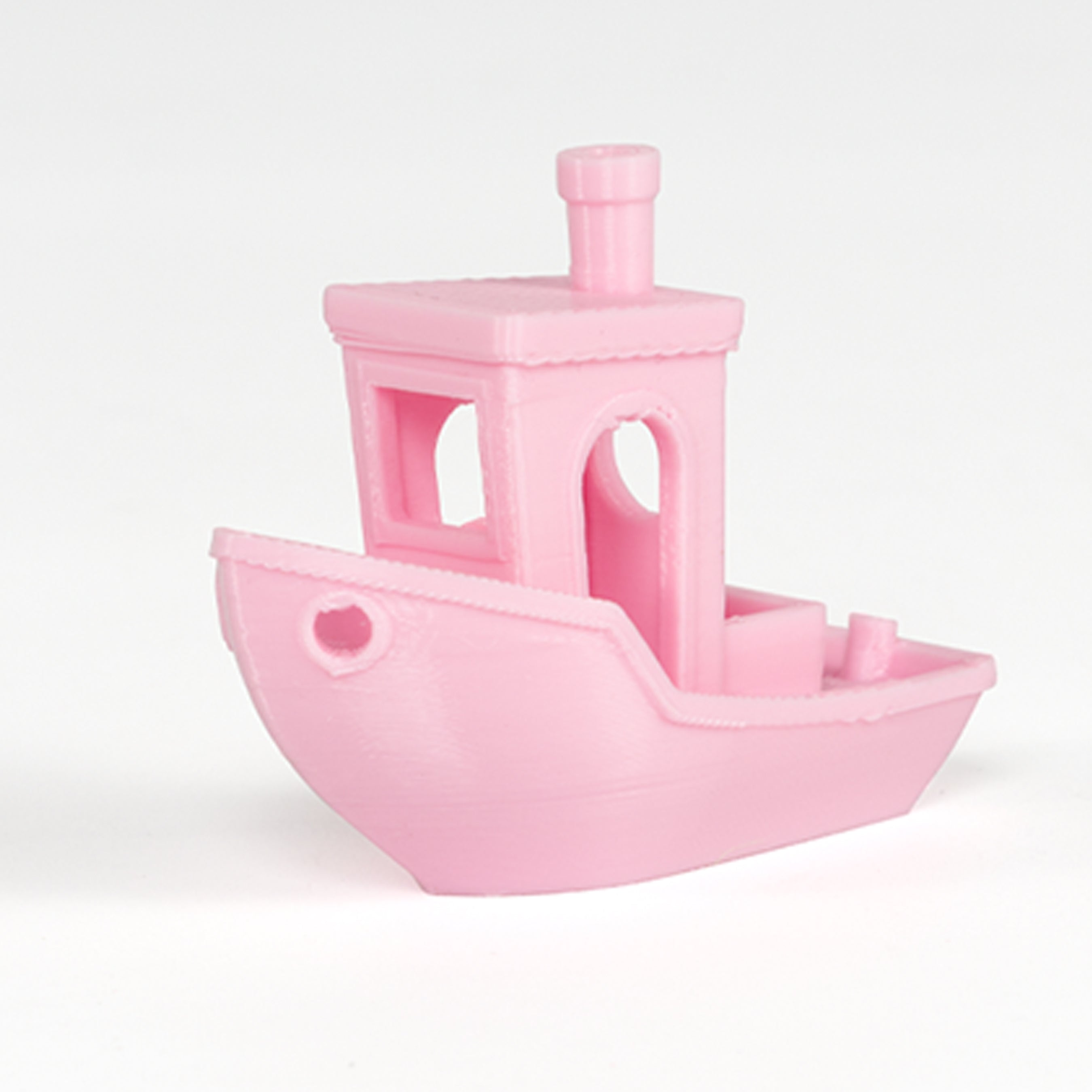 Pink toy boat on a white background