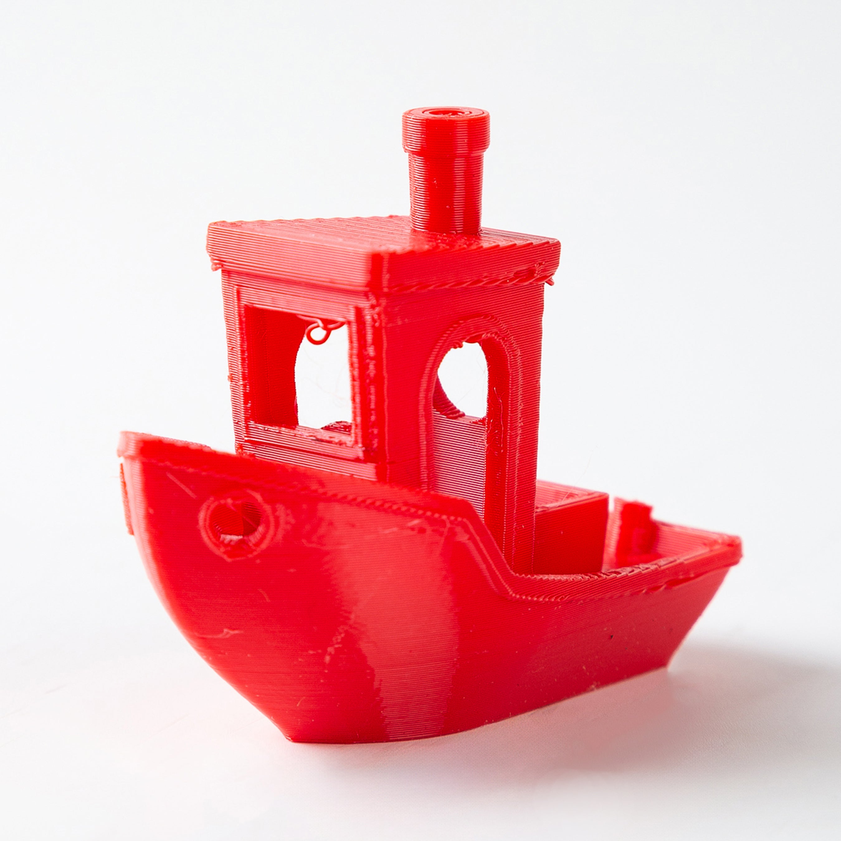 Red toy boat on a white background