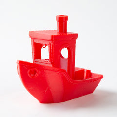 Red toy boat on a white background