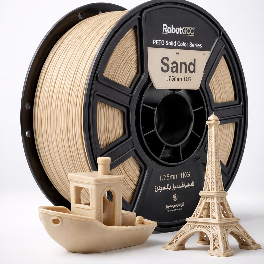 Spool of sand-colored 3D printing filament with small models made from it on a white background