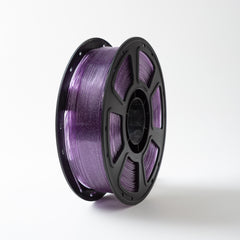 Spool of purple filament on a white background