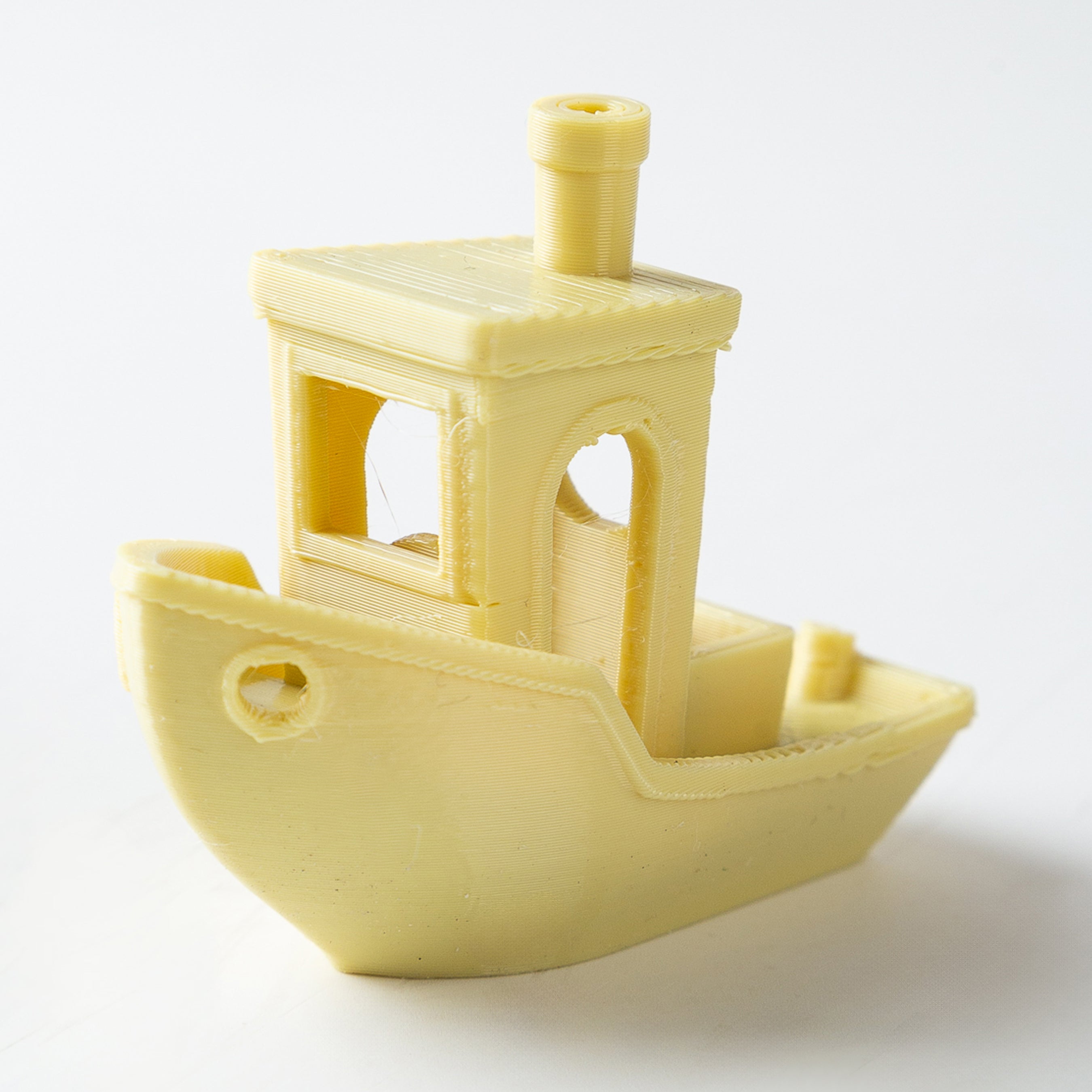 Yellow toy boat on a white background