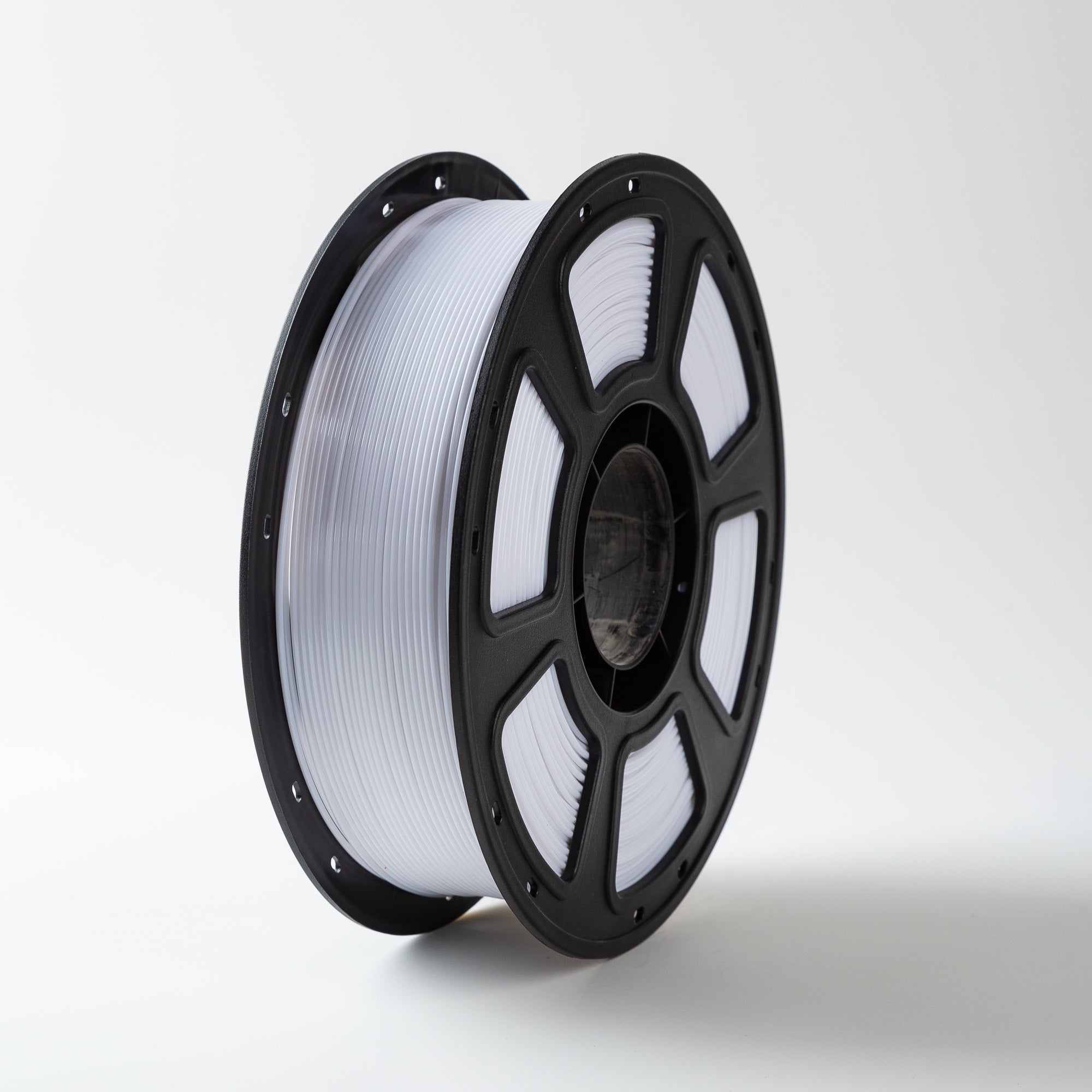 Spool of white filament on a black reel against a white background