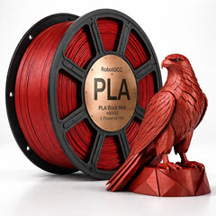 Red PLA filament spool with a 3D printed red eagle sculpture on a white background