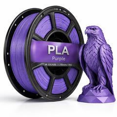 Spool of purple PLA filament and a purple 3D-printed eagle sculpture on a white background
