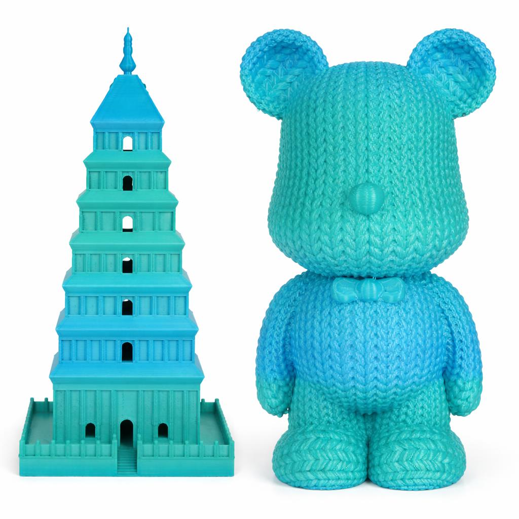 Turquoise toy bear and tower of Babel model on a white background