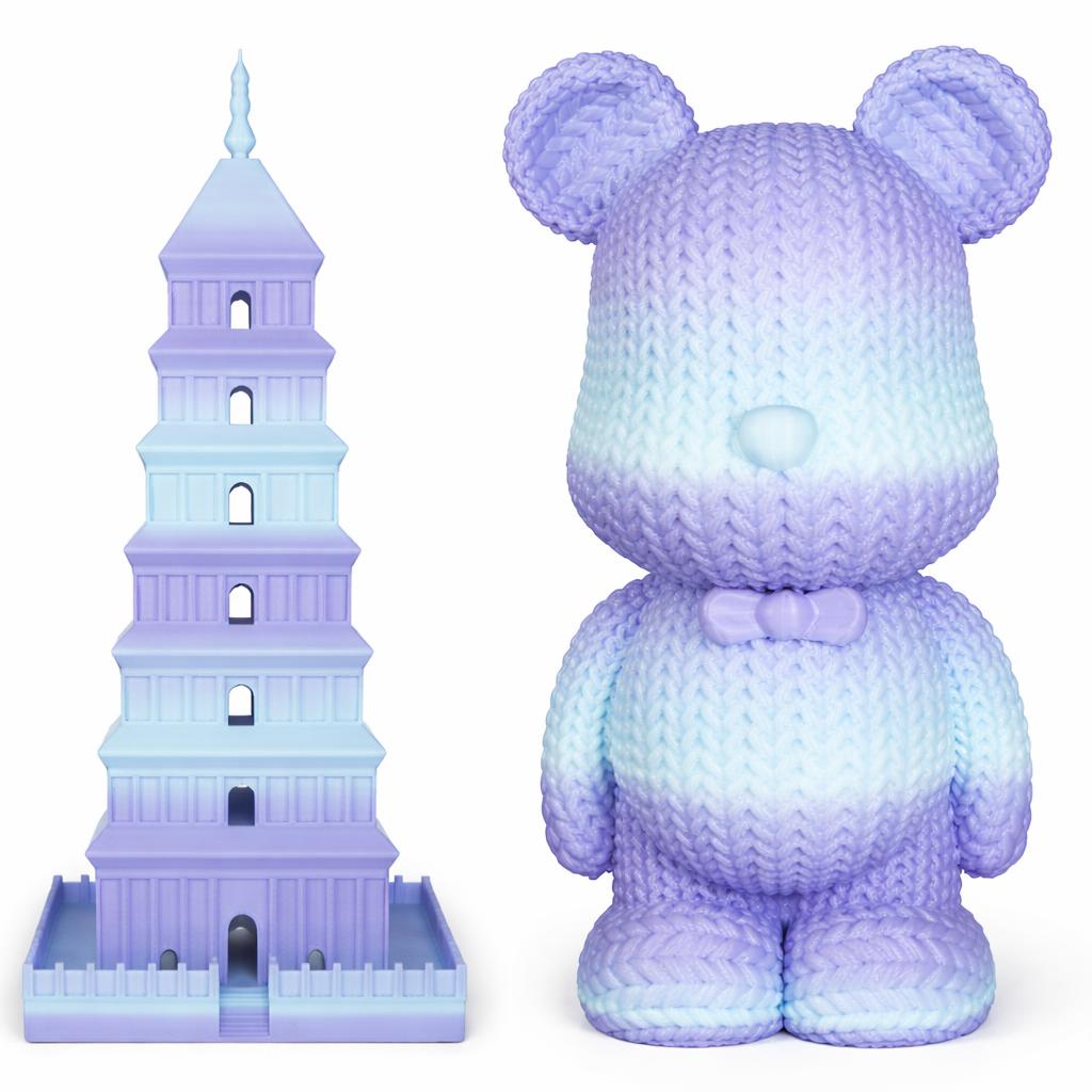 Gradient purple and blue teddy bear next to a tower model on a white background