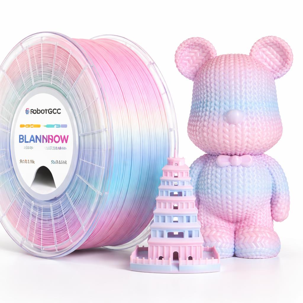 Spool of pink and blue filament with a pink and blue 3D printed tower and bear figure on a white background.