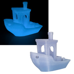 Glowing blue and white toy boat on a black and white background
