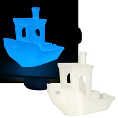 Blue and white toy boat models on a black and white background