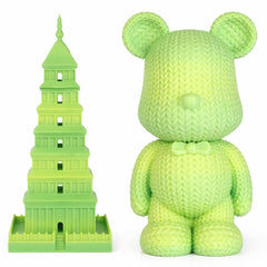 Green knitted bear and green tower toy on a white background