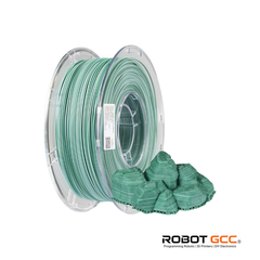 Spool of green filament with a small model piece on a white background, featuring the ROBOT GCC logo.