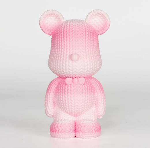 Pink teddy bear plush toy on a light gray background