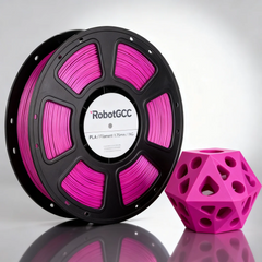 Spool of pink 3D printing filament and a geometric pink object on a reflective surface.