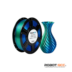 Spool of blue 3D printing filament and a blue and green vase on a white background with Robot GCC branding.