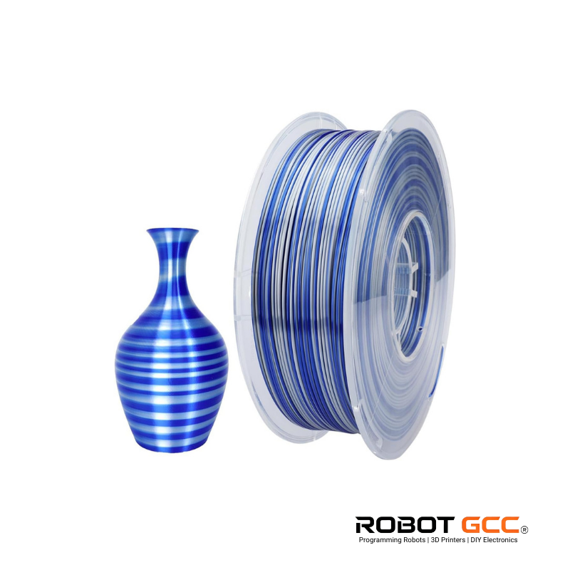 Spool of blue and white striped filament next to a striped vase on a white background with Robot GCC logo.