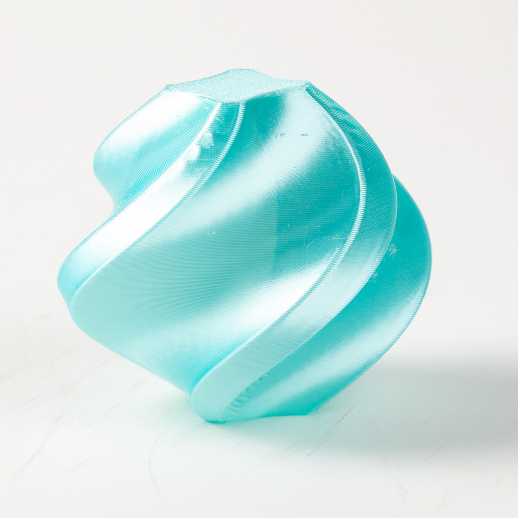 Turquoise plastic component on a white background