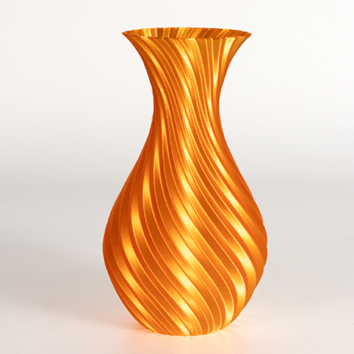 Orange glass vase with wavy pattern on a light gray background