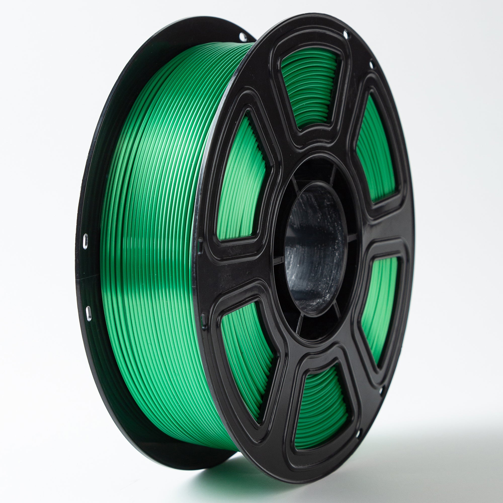 Spool of green filament on a white background