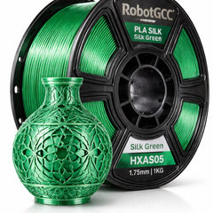 Green 3D printed vase next to a spool of RobotGCC PLA Silk filament on a white background