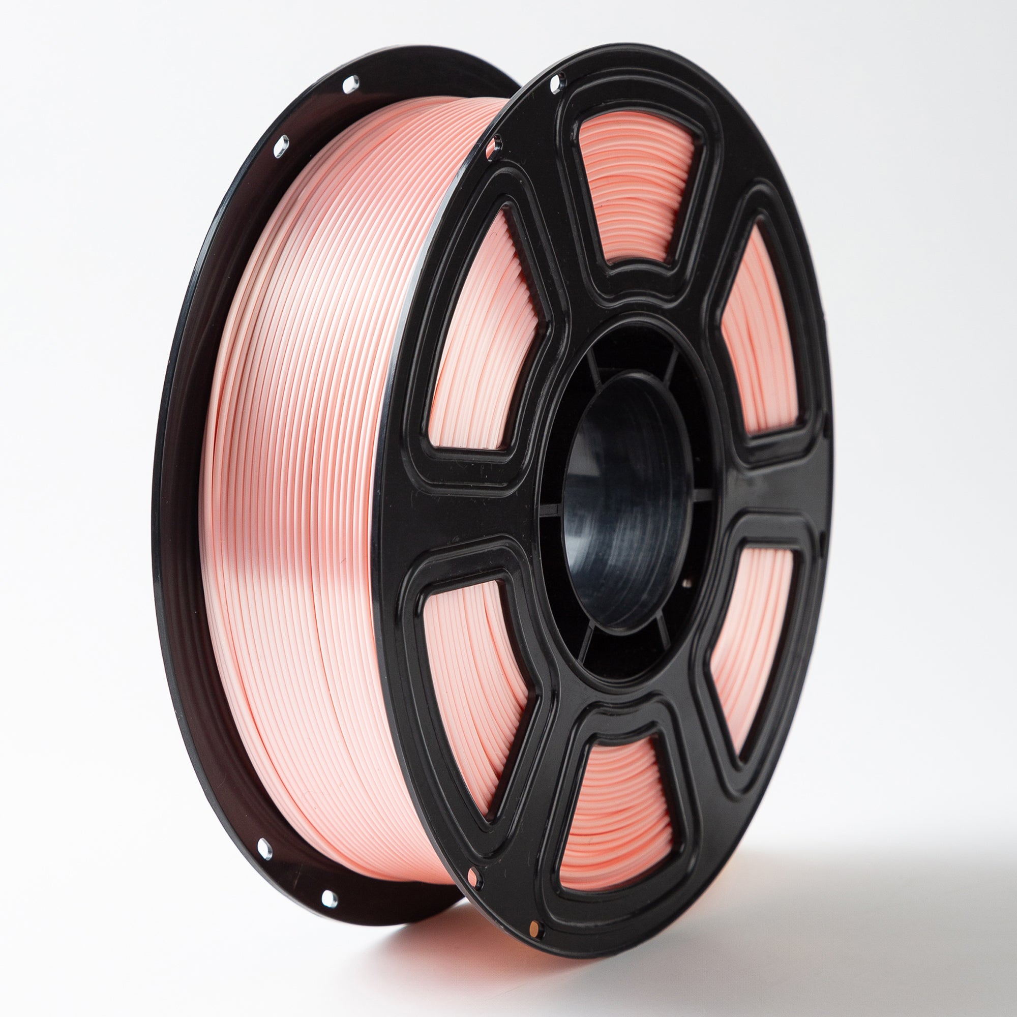 Spool of pink wire on a black reel against a white background