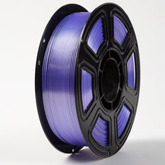 Spool of purple filament on a white background