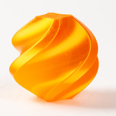 Orange, wavy, 3D-printed object on a white background