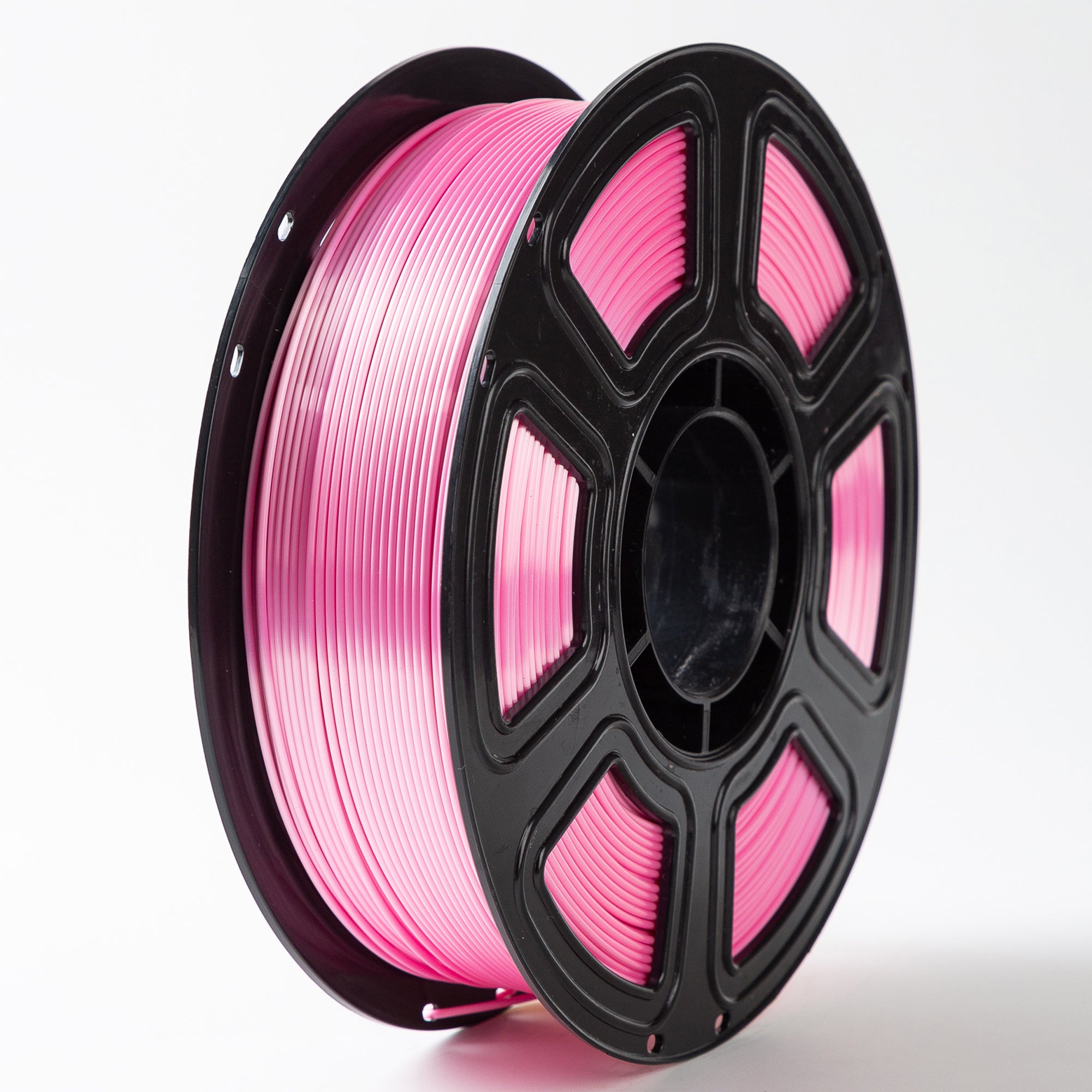 Spool of pink filament on a white background