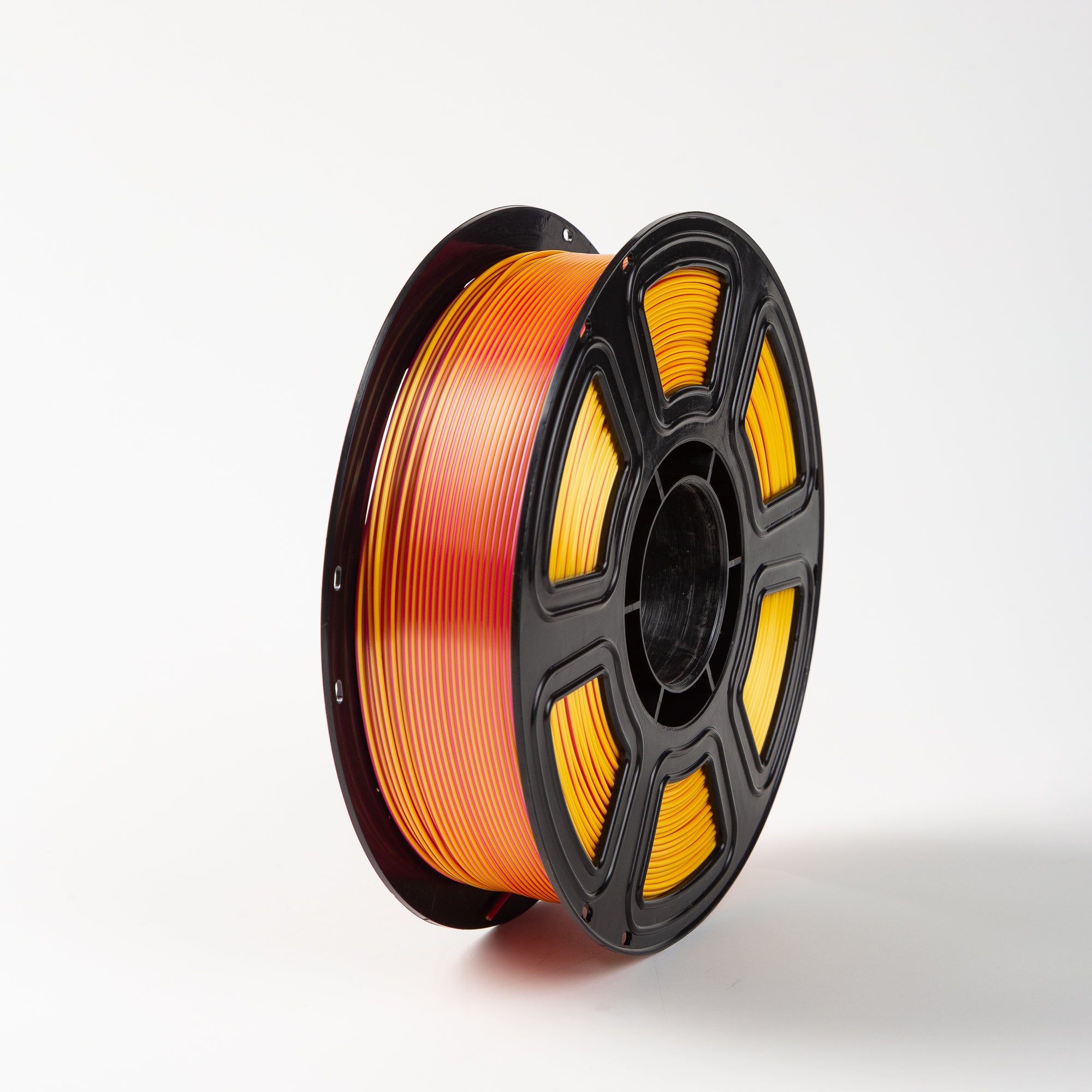 Spool of orange filament on a white background