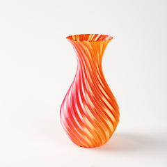 Orange and red striped glass vase on a white background