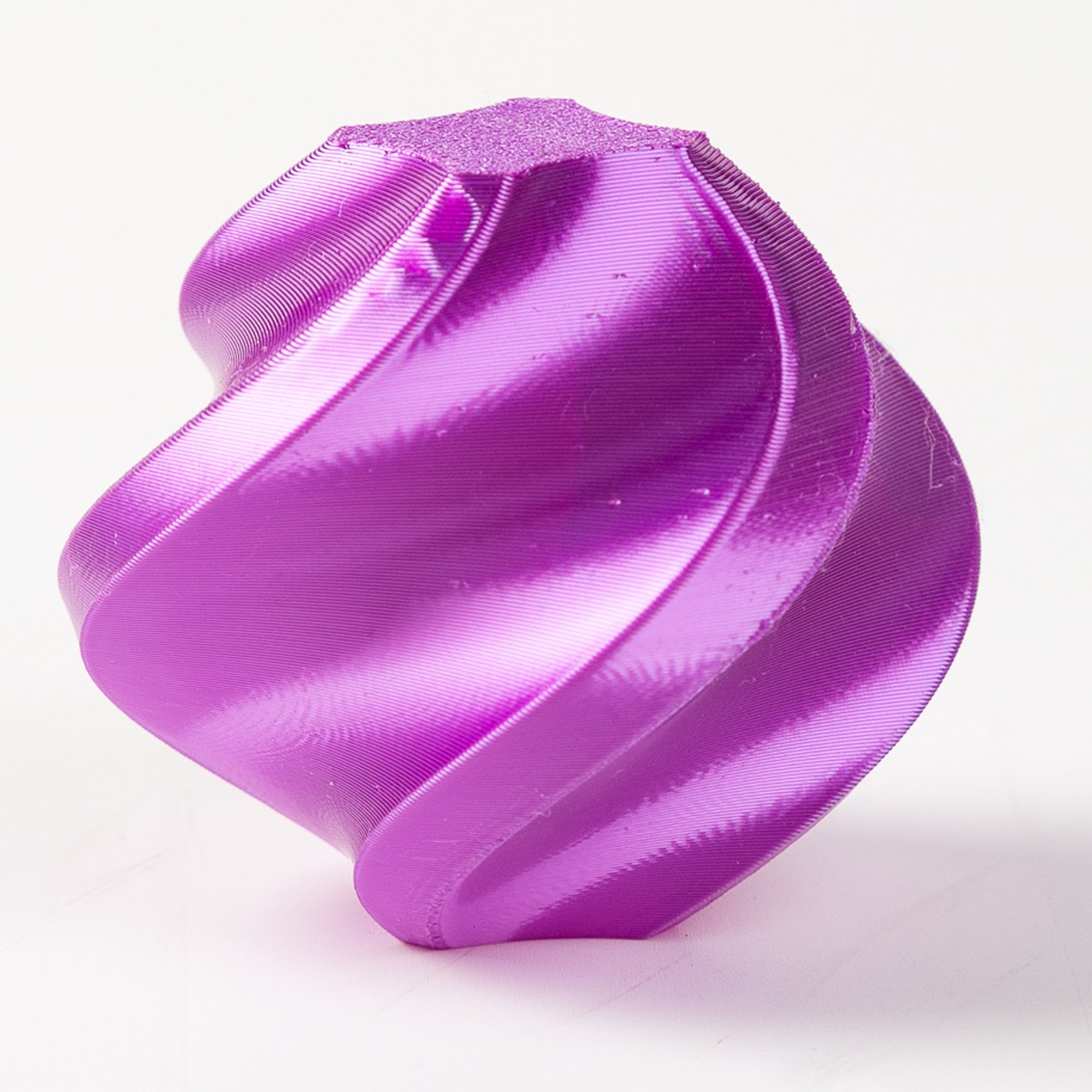 Purple plastic component on a white background