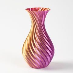Decorative glass vase with pink and gold swirl pattern on a white background