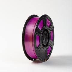 Spool of purple filament on a white background