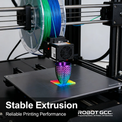3D printer with colorful object on the bed, featuring ROBOT GCC branding.