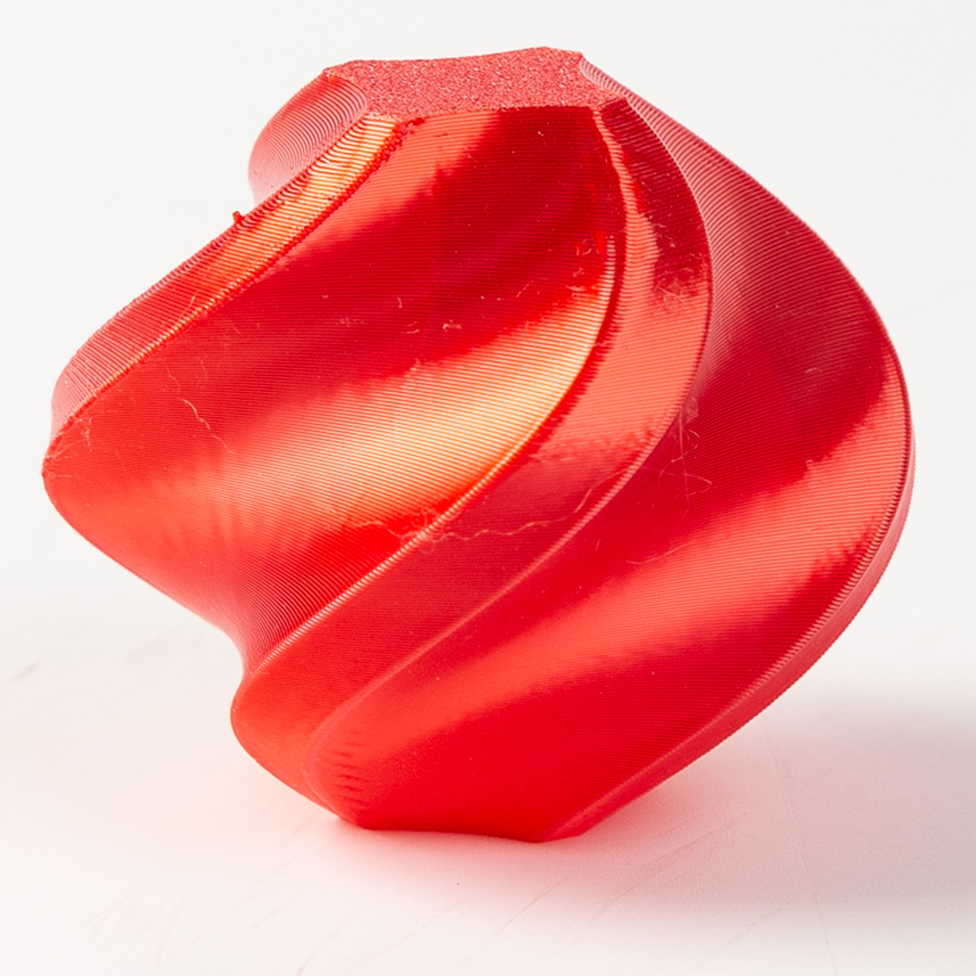 Red 3D-printed object on a white background
