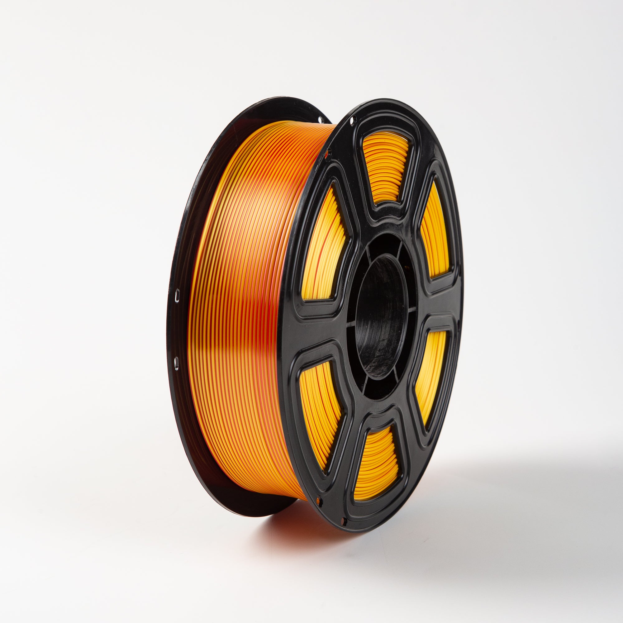 Spool of yellow filament on a white background