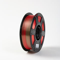 Spool of red filament on a white background