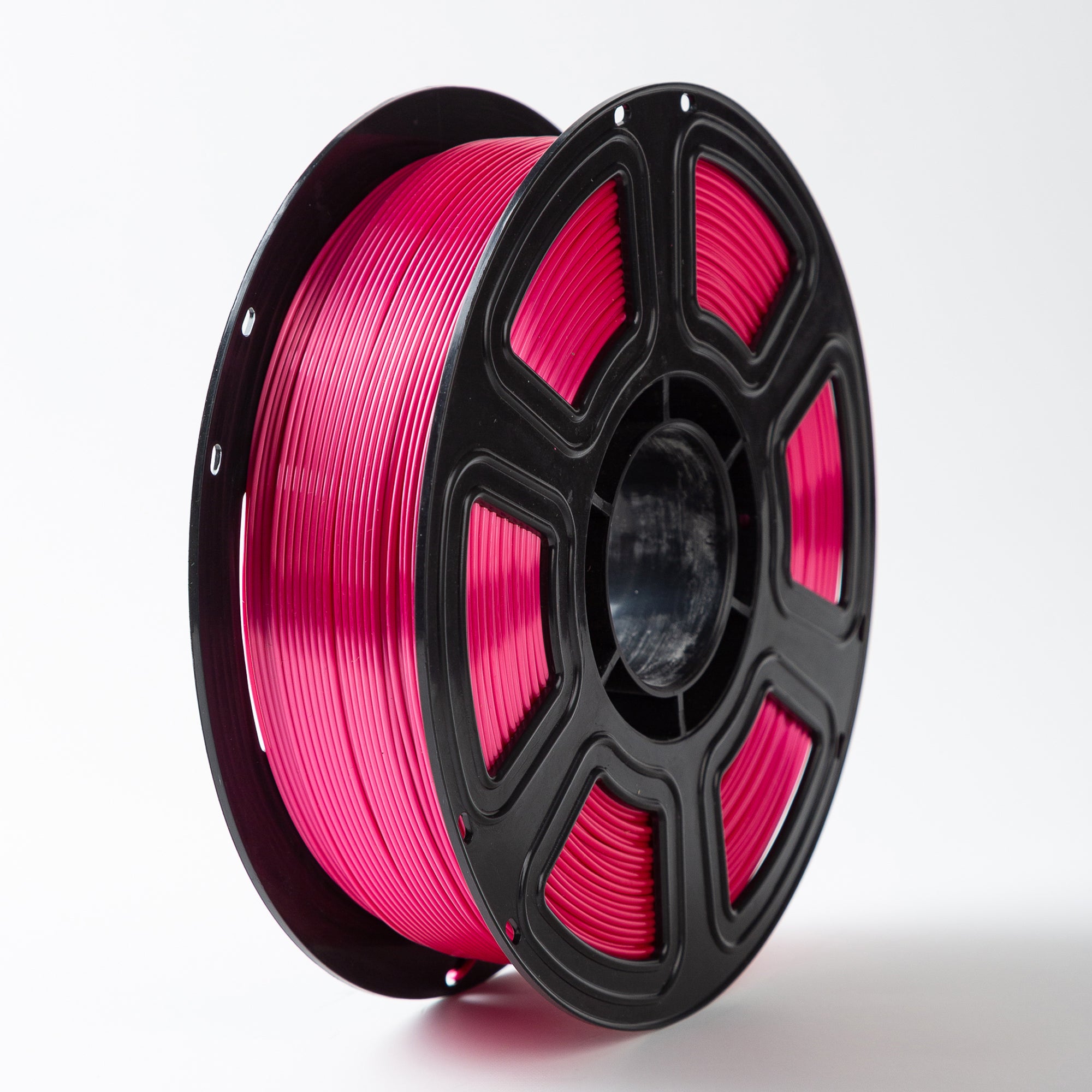 Spool of pink filament on a white background