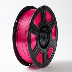 Spool of pink filament on a white background