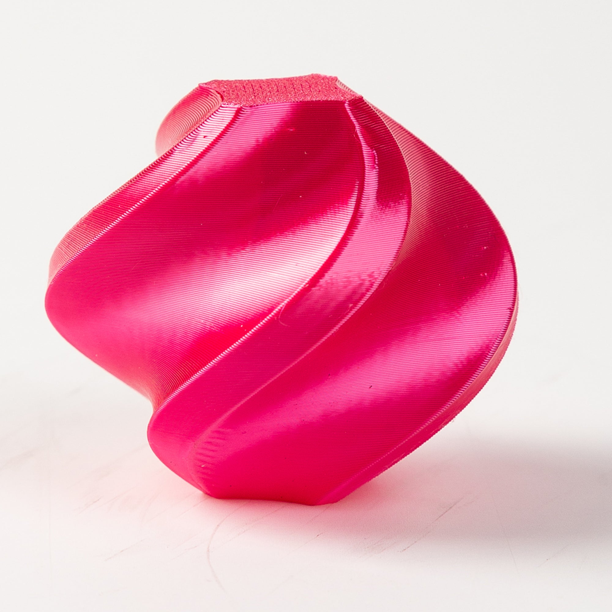 Pink plastic component on a white background