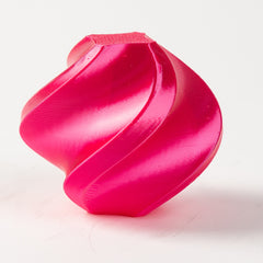 Pink plastic component on a white background