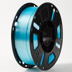 Spool of blue filament on a black plastic spool against a white background