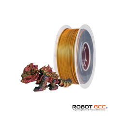 Spool of gold filament next to a small model on a white background with 'Robot GCC' branding.