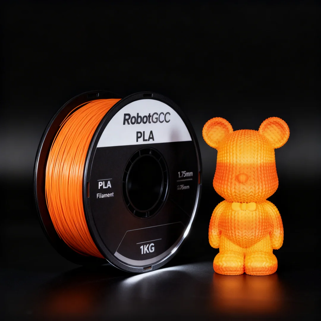 Spool of orange 3D printing filament and a small orange 3D printed bear figure on a black background