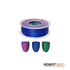 Spool of blue filament with three colorful 3D printed objects on a white background, featuring the ROBOT GCC logo.