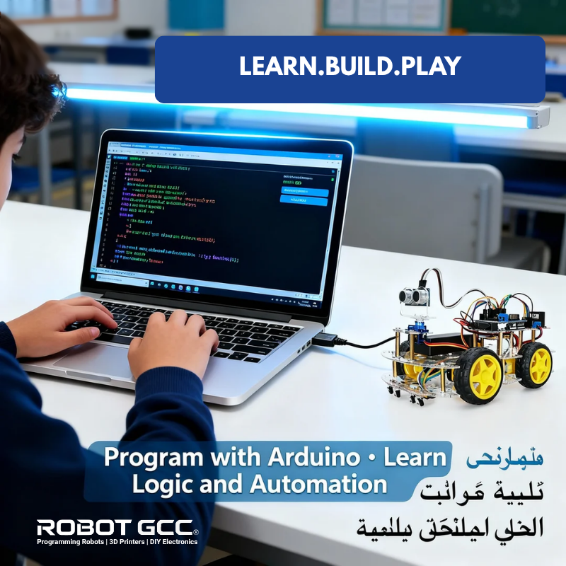 Person programming on a laptop with a robot attached, in a classroom setting, featuring 'LEARN.BUILD.PLAY' text.